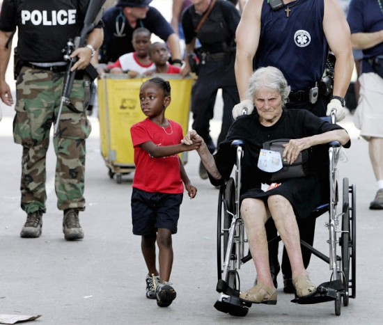 Tanisha Blevin, 5, holds the hand of fellow Hurricane Katrina victim Nita LaGarde, 105, as they are evacuated from the convention center in New Orleans.