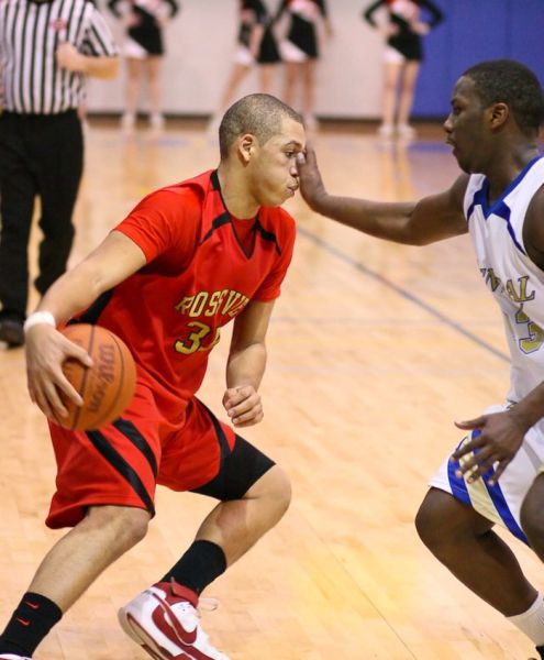 Wilson Central's JaJuan Brooks, right, gets a hand in the face of Rossview's Jonathan Williams, left, as Wilson Central went on to beat Rossview 68 to 49 at Wilson Central High School in Gladeville. More photos available at www.midtnsportsphotos.com.