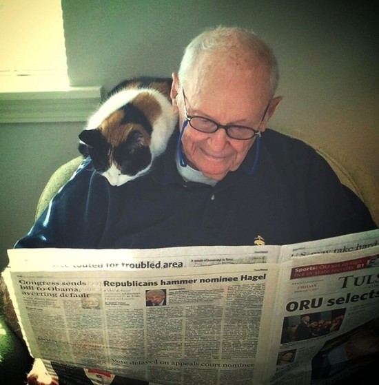 Cat and grandpa reading the news