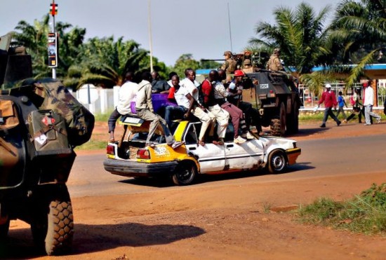 A packed taxi drives past a French checkpoint in Bangui, Central
