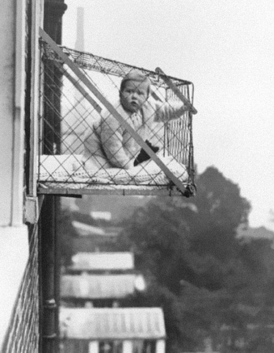 Baby cages used to ensure that children get enough sunlight and fresh air when living in an apartment building, ca. 1937