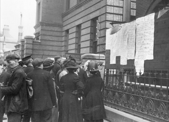 People in Southampton checking the Titanic survivor list posted outside the White Star Line office. April, 1912