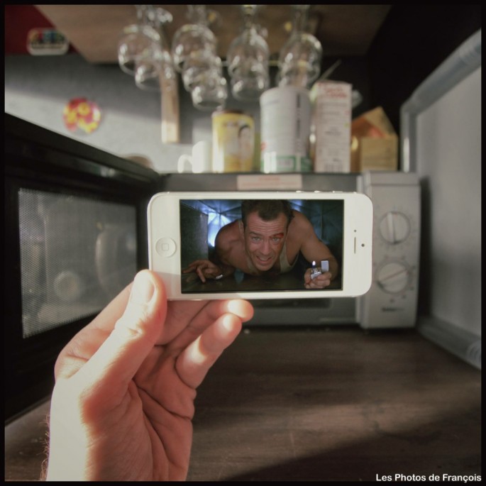Movie and TV scenes on an iPhone held up in front of perfect real-life backgrounds 013