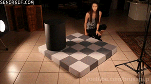 The gray tiles she’s moving are actually the same color
