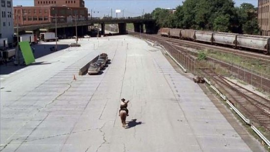 actor Andrew Lincoln riding a horse in a parking lot